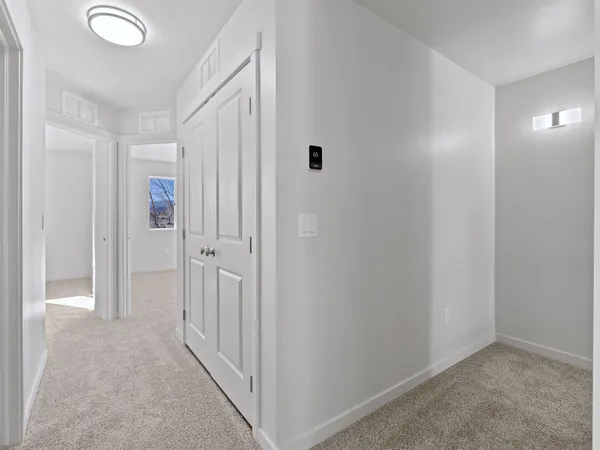 a living room with a bed and a dresser next to a window