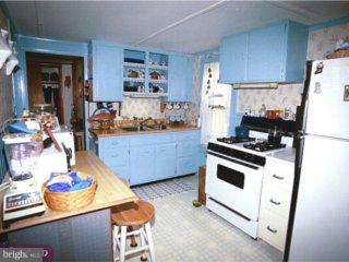 99 Gelsinger Road Sinking Spring, PA 19608 - Photo 5 of 6 a kitchen with stainless steel appliances a stove a refrigerator and a cabinets