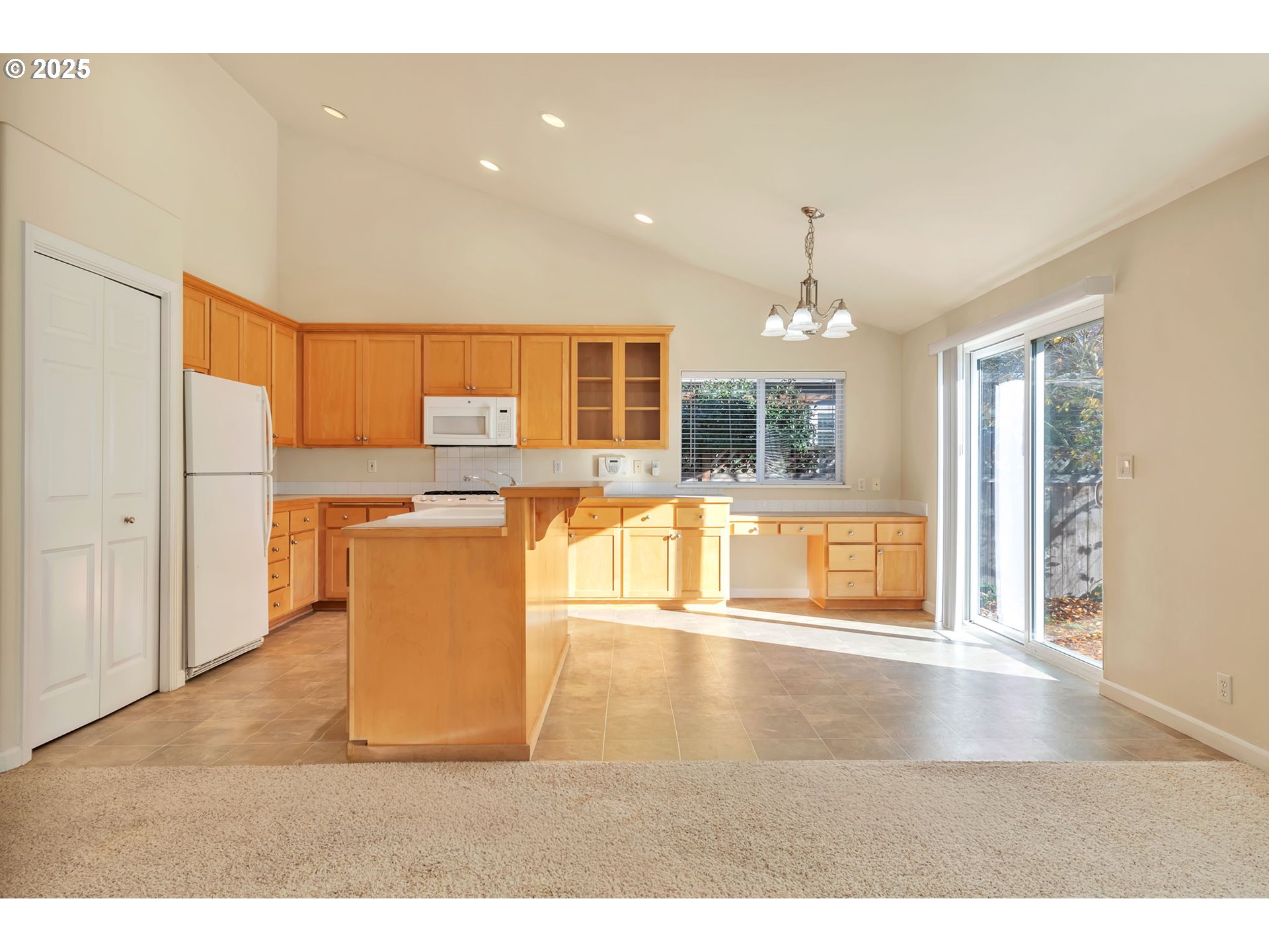 158 Mackin Avenue Eugene, OR 97404 - Photo 18 of 45 a living room with stainless steel appliances kitchen island granite countertop a refrigerator a stove top oven and a view of living room