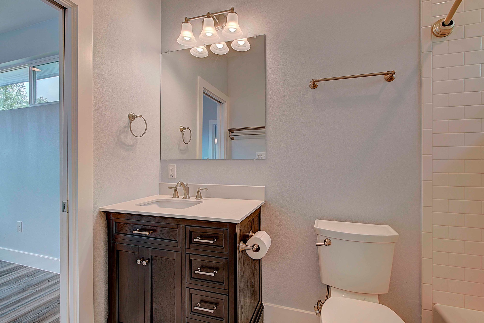 806 West Live Oak Street, Unit 2 Austin, TX 78704 - Photo 14 of 16 a bathroom with a toilet a sink and mirror