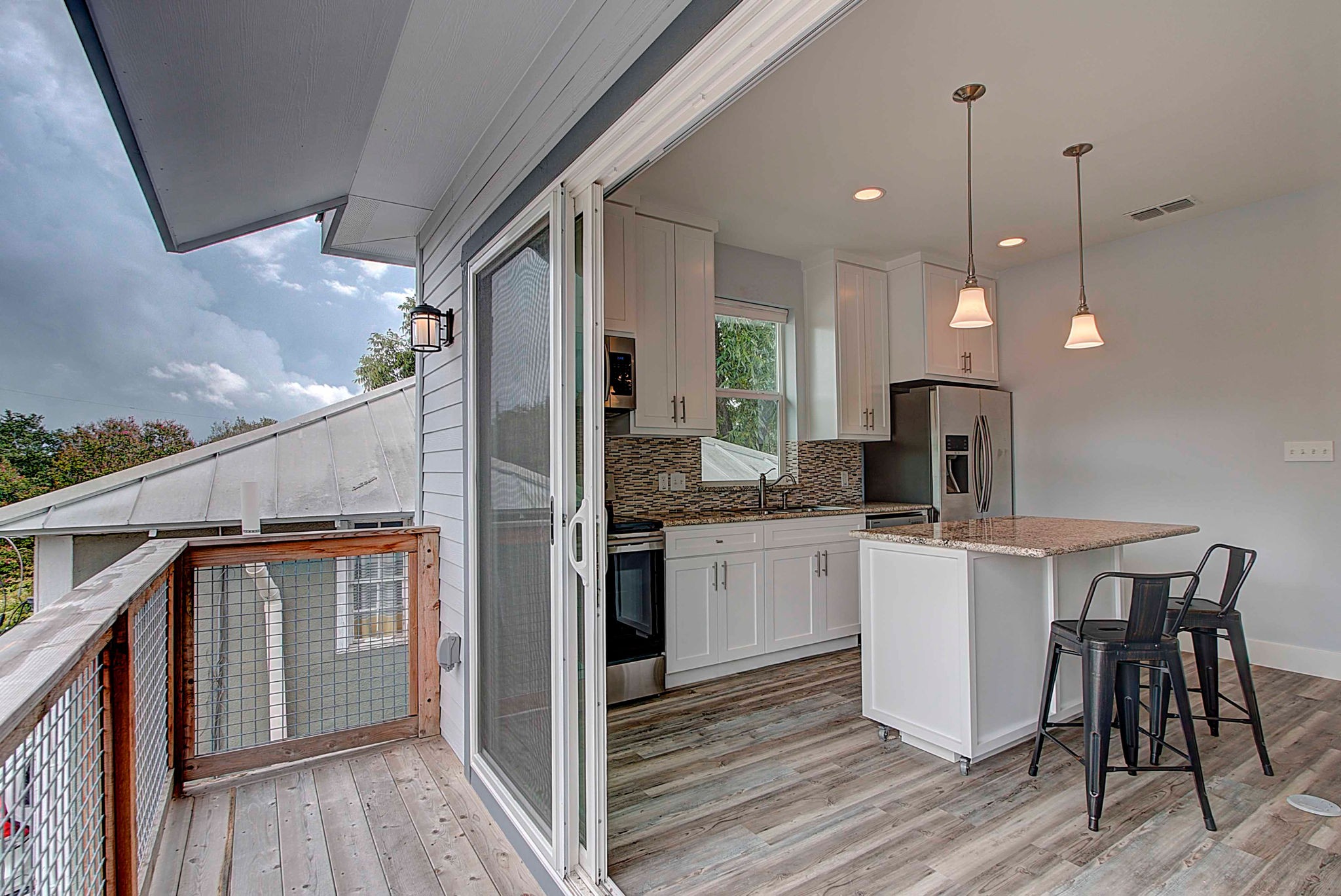 806 West Live Oak Street, Unit 2 Austin, TX 78704 - Photo 15 of 16 a kitchen with kitchen island a counter top space a sink stainless steel appliances and cabinets