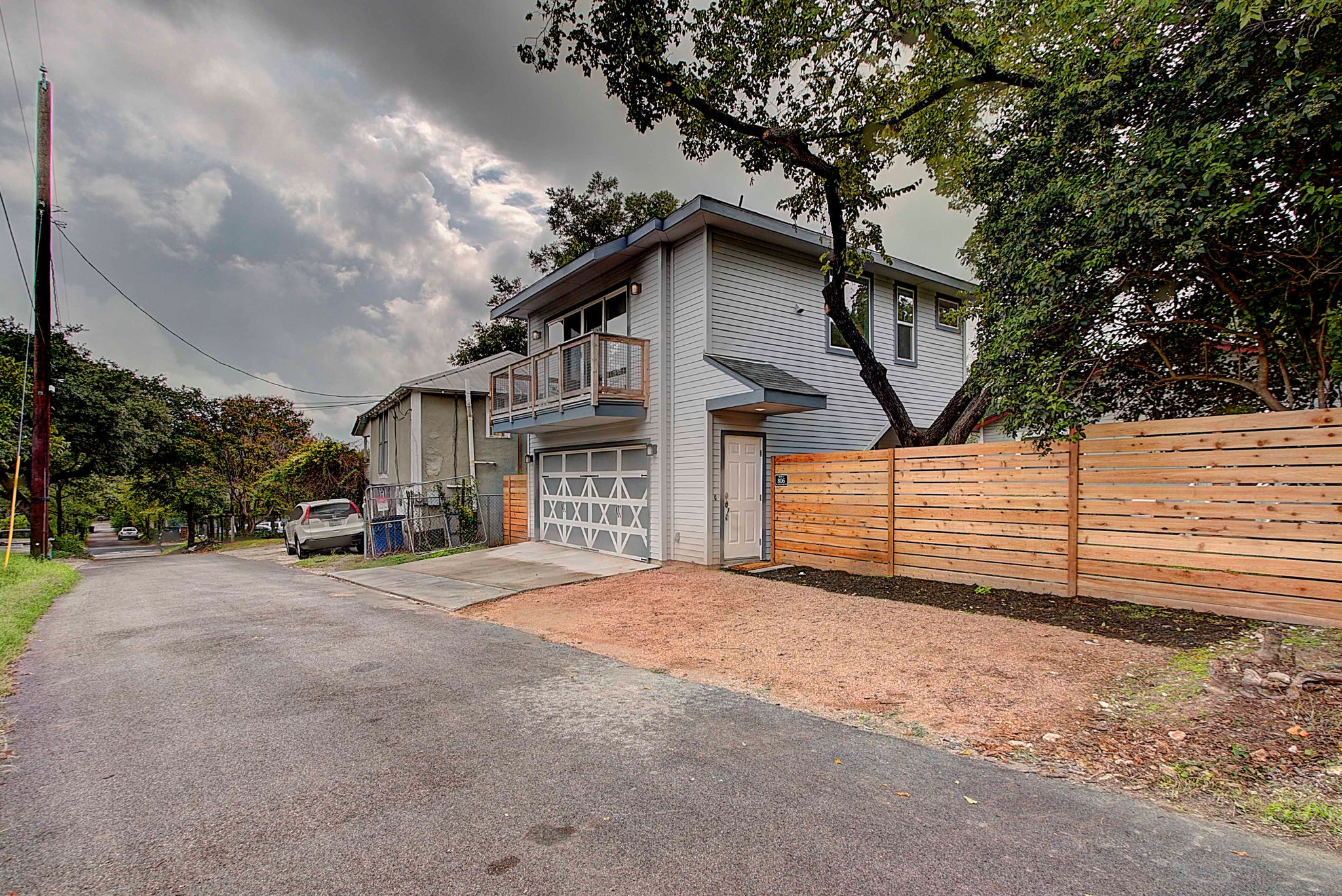 806 West Live Oak Street, Unit 2 Austin, TX 78704 - Photo 2 of 16 a view of a house with a yard and garage
