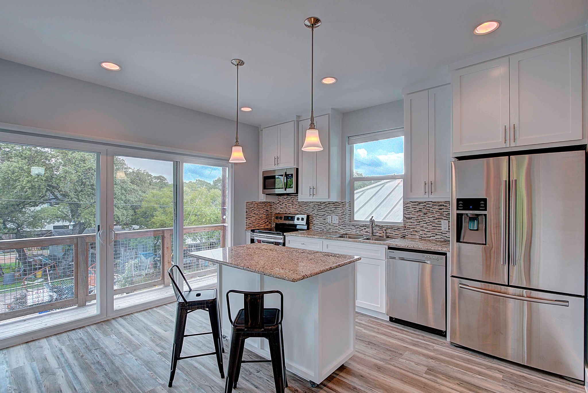 806 West Live Oak Street, Unit 2 Austin, TX 78704 - Photo 6 of 16 a kitchen with a table chairs refrigerator and microwave