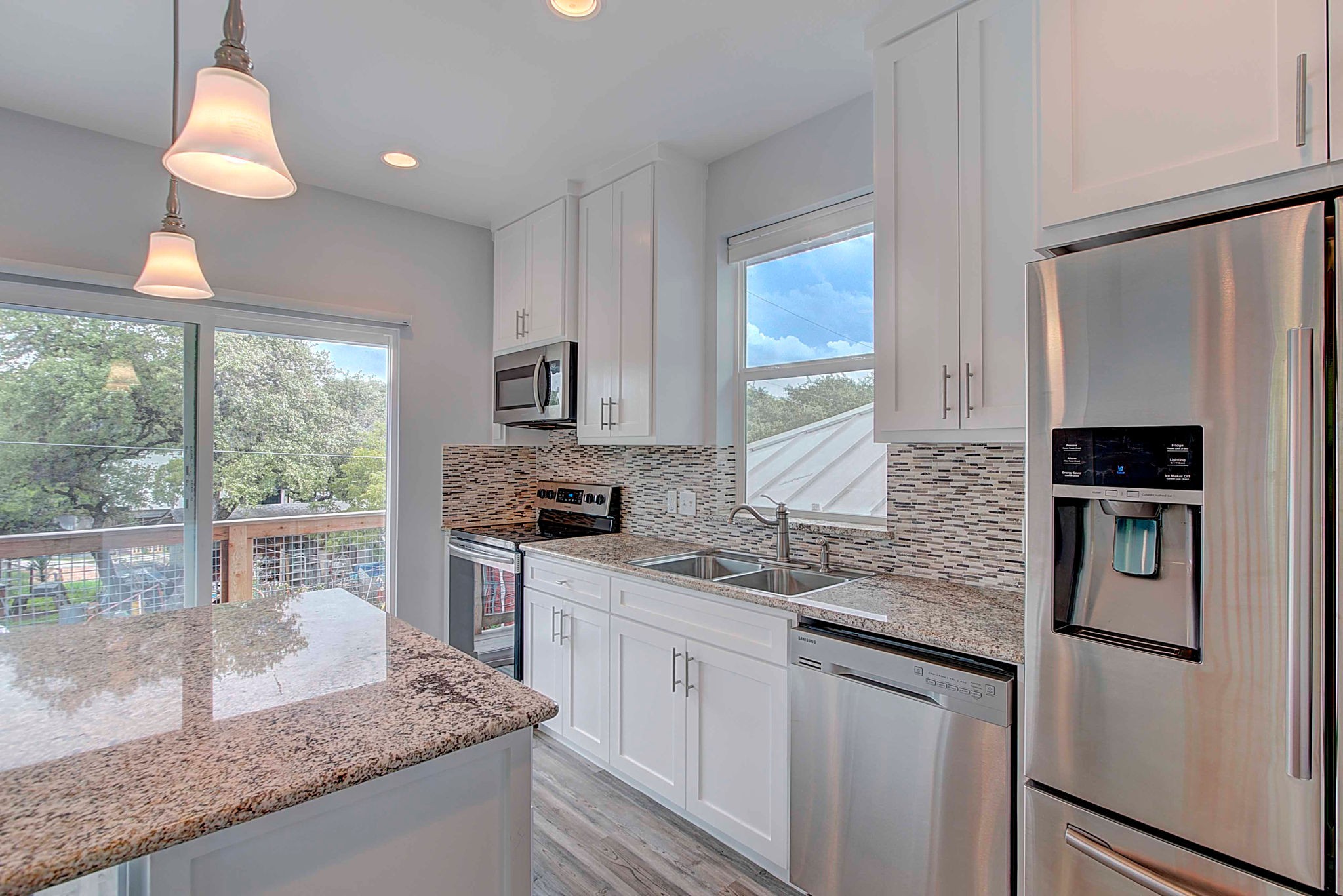 806 West Live Oak Street, Unit 2 Austin, TX 78704 - Photo 8 of 16 a kitchen with granite countertop kitchen island stainless steel appliances a sink stove and a window