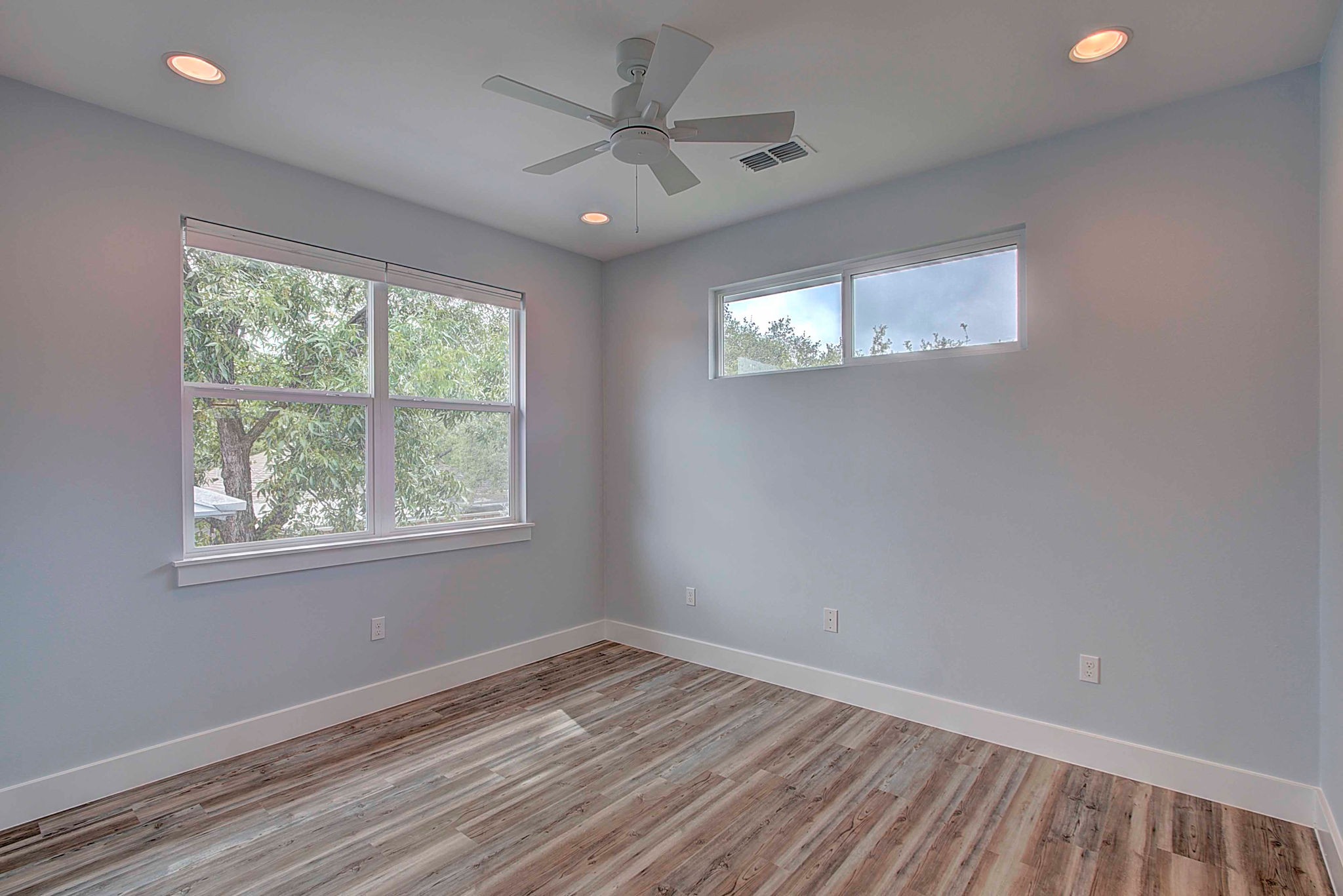 806 West Live Oak Street, Unit 2 Austin, TX 78704 - Photo 10 of 16 a view of empty room with wooden floor and fan