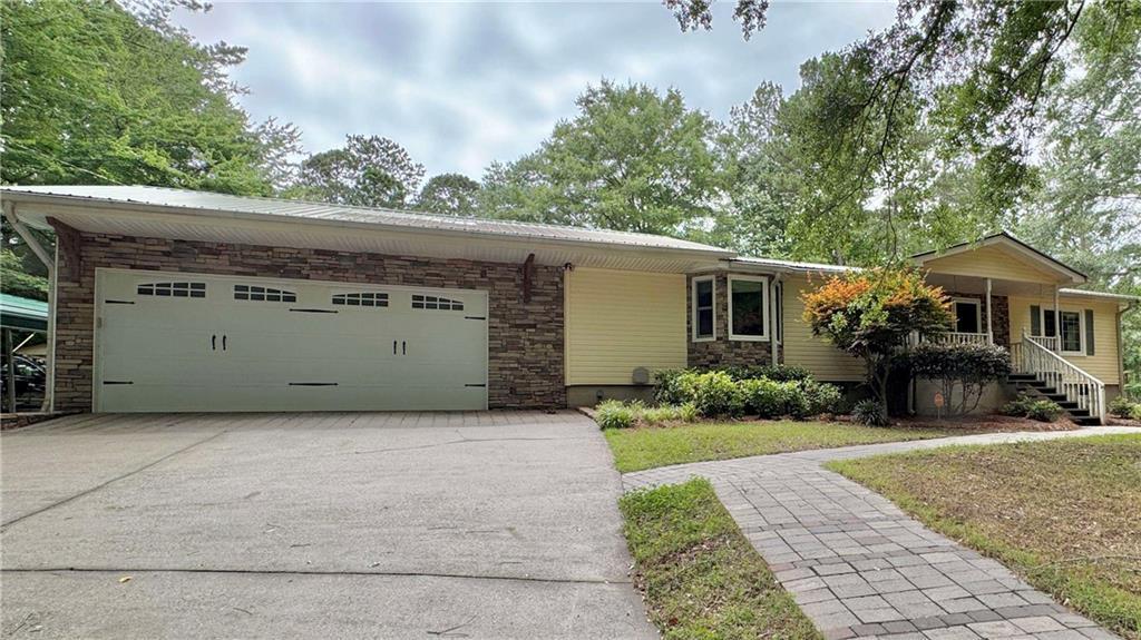 90 Howard Road Senoia, GA 30276 - Photo 23 of 73 a front view of a house with a yard and garage