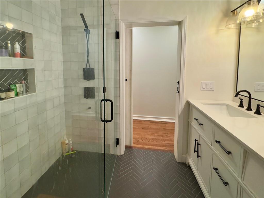 90 Howard Road Senoia, GA 30276 - Photo 35 of 73 a bathroom with a double vanity sink a mirror and a shower