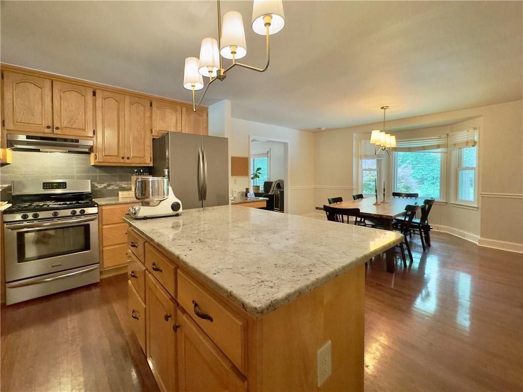 90 Howard Road Senoia, GA 30276 - Photo 4 of 73 a kitchen with stainless steel appliances granite countertop a stove refrigerator and a view of living room