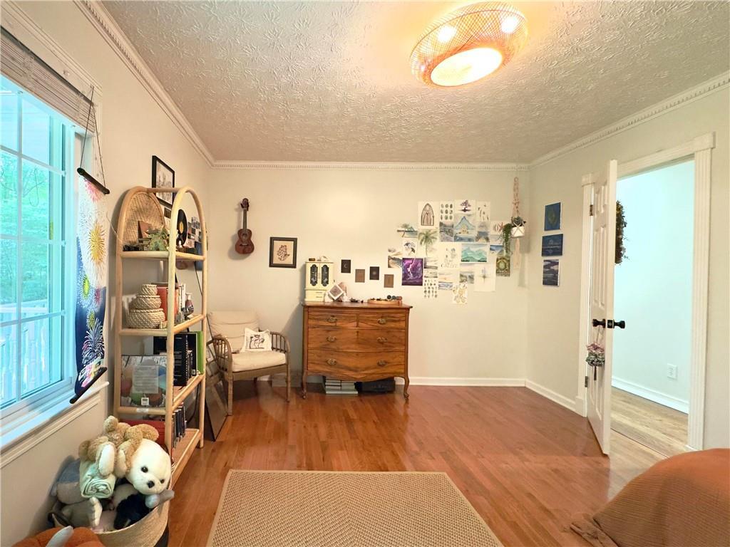 90 Howard Road Senoia, GA 30276 - Photo 42 of 73 a living room with furniture and a wooden floor