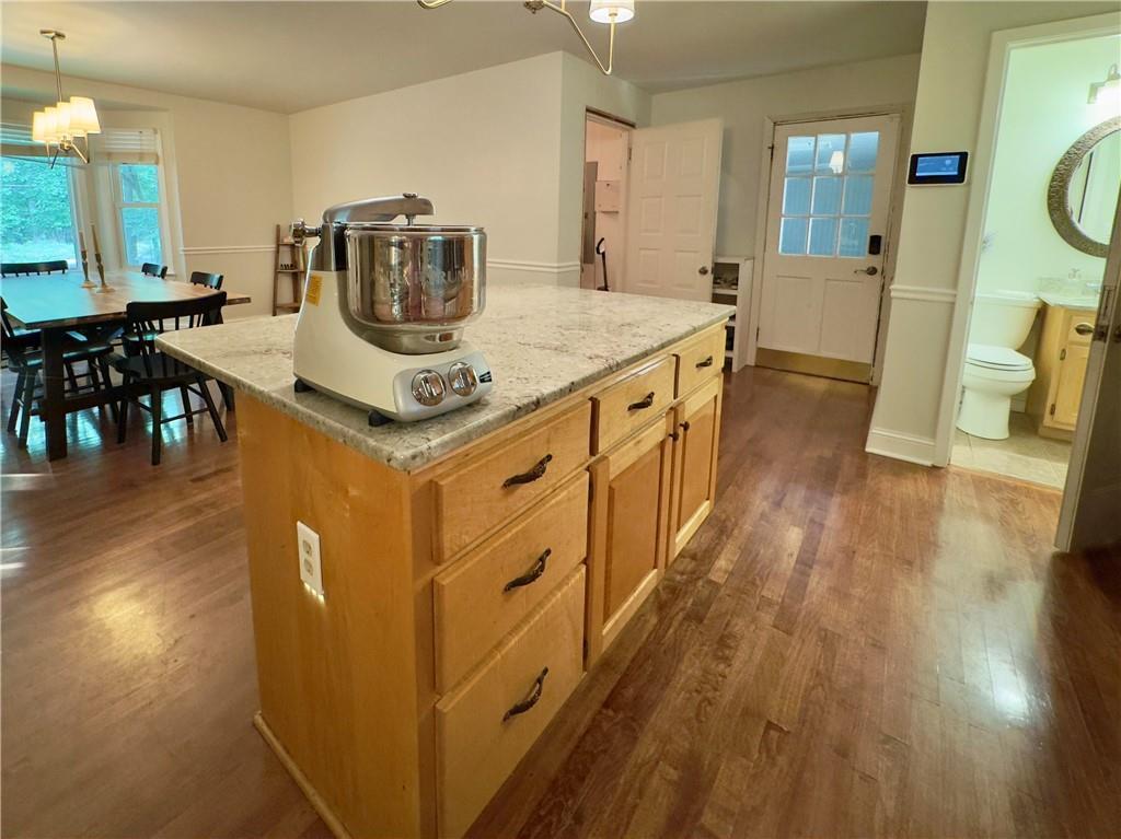 90 Howard Road Senoia, GA 30276 - Photo 49 of 73 a kitchen with stove and wooden floor