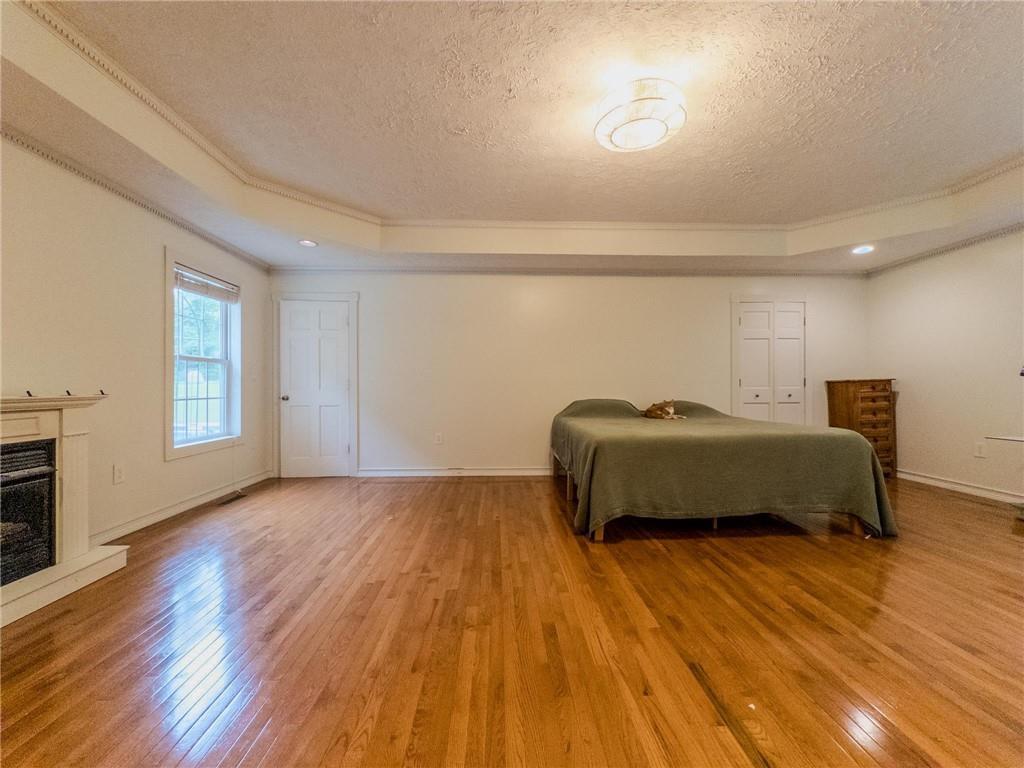 90 Howard Road Senoia, GA 30276 - Photo 55 of 73 a bedroom with a bed and wooden floor