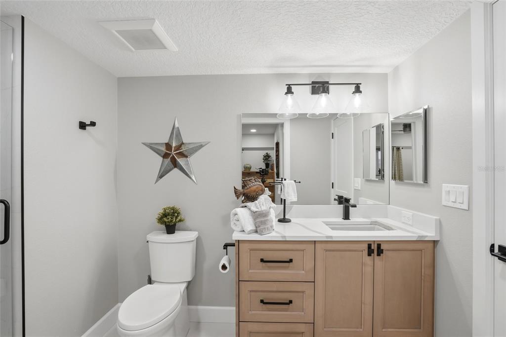 363 Pinellas Bayway South, Unit 29 Tierra Verde, FL 33715 - Photo 7 of 59 a bathroom with a sink a toilet and mirror