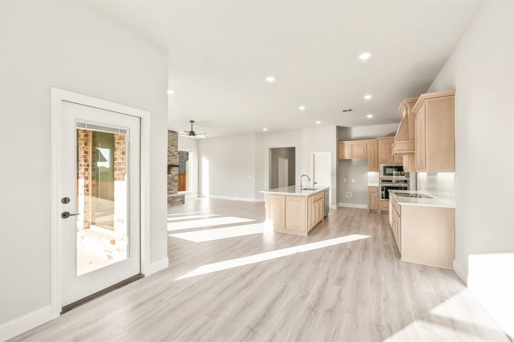 34 Osprey Street Joshua, TX 76058 - Photo 18 of 36 a view of a kitchen with kitchen island a counter top space a sink stainless steel appliances and cabinets
