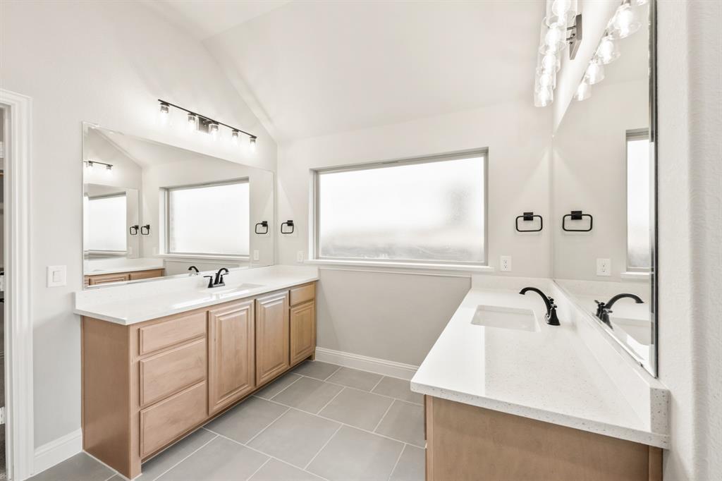 34 Osprey Street Joshua, TX 76058 - Photo 22 of 36 a view of a bathroom with a sink and mirror