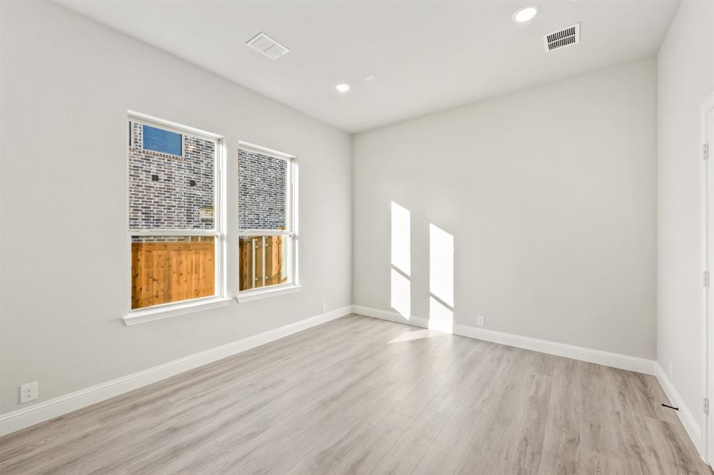 34 Osprey Street Joshua, TX 76058 - Photo 8 of 36 an empty room with wooden floor and windows
