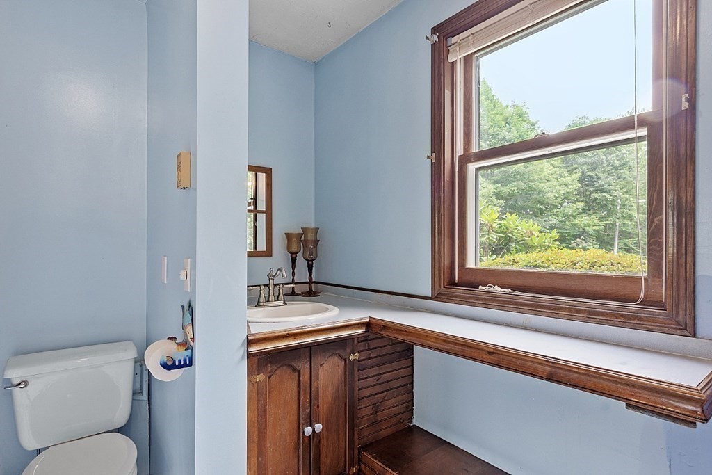 176 Ellis Road Westminster, MA 01473 - Photo 29 of 42 a bathroom with a granite countertop toilet sink and mirror