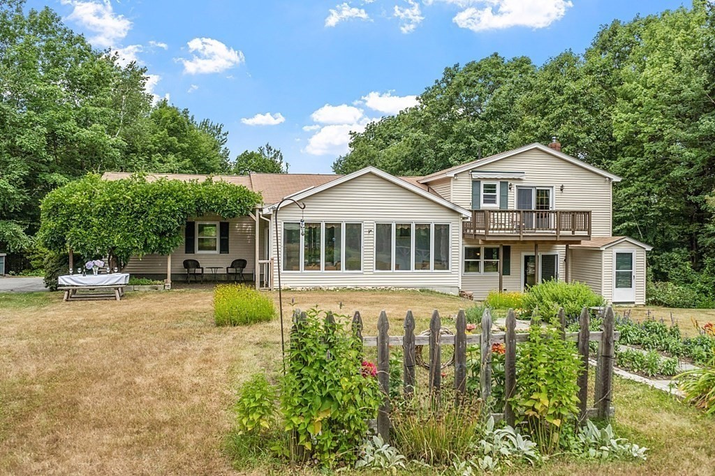 176 Ellis Road Westminster, MA 01473 - Photo 33 of 42 a white house with a large pool and lawn chairs under an umbrella