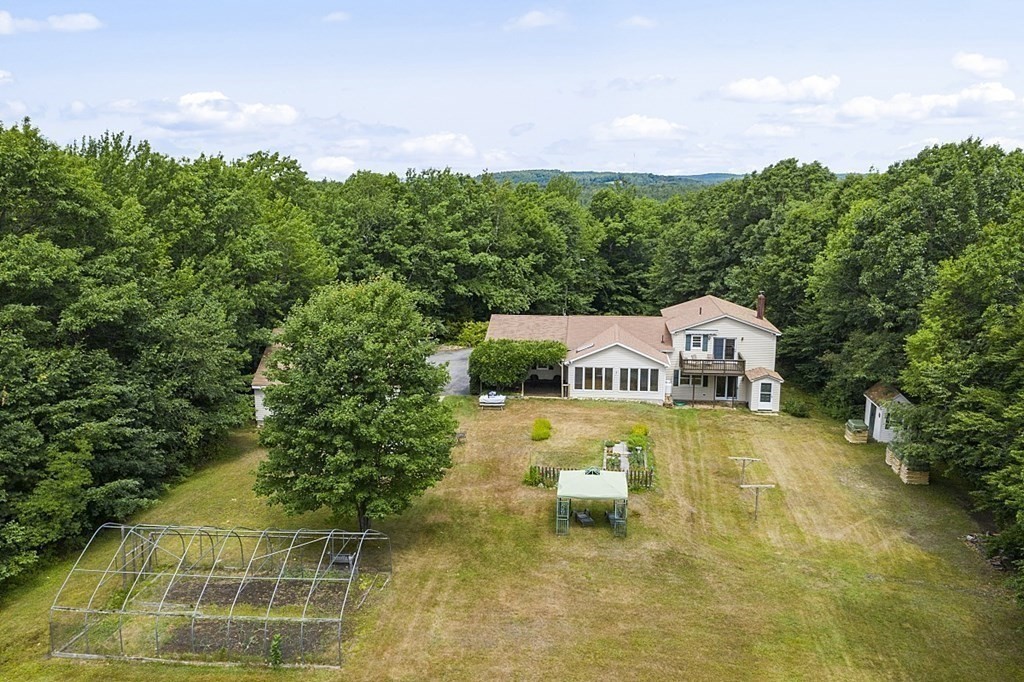 176 Ellis Road Westminster, MA 01473 - Photo 37 of 42 a front view of a house with a yard and trees