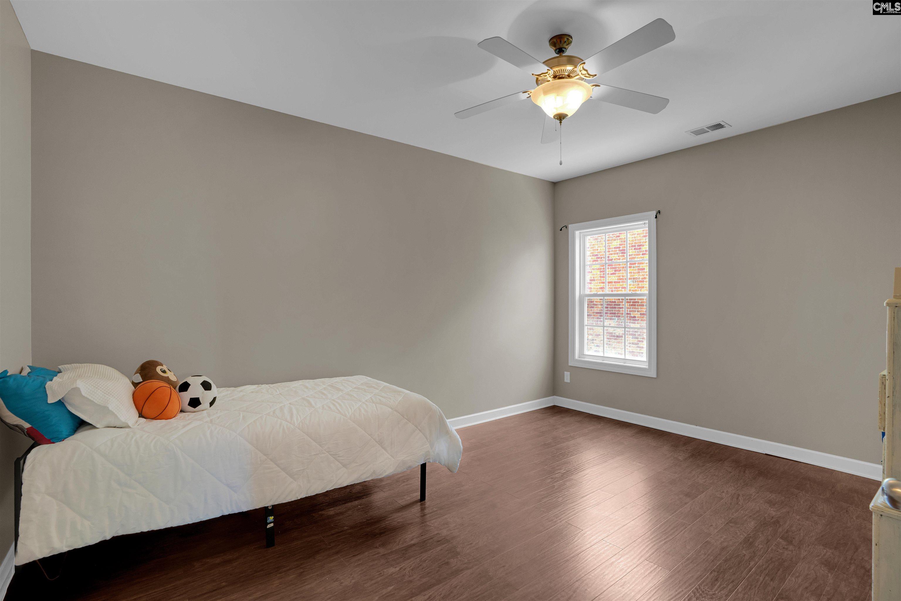 321 Asa Rose Lexington, SC 29072 - Photo 34 of 52 a bedroom with a bed and a chandelier fan