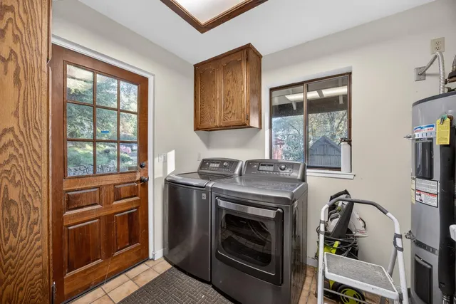 a living room with fireplace furniture and a floor to ceiling window