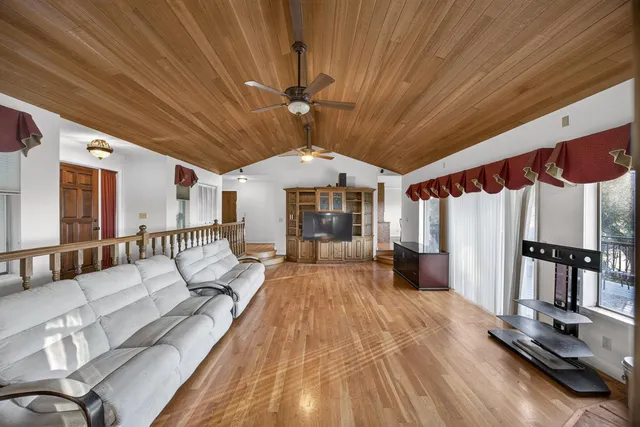 a kitchen with stainless steel appliances granite countertop a refrigerator a stove and a sink