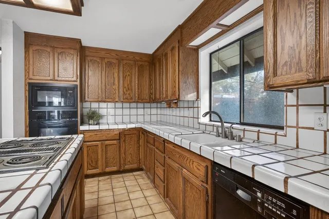 a spacious bathroom with a granite countertop sink mirror vanity and toilet