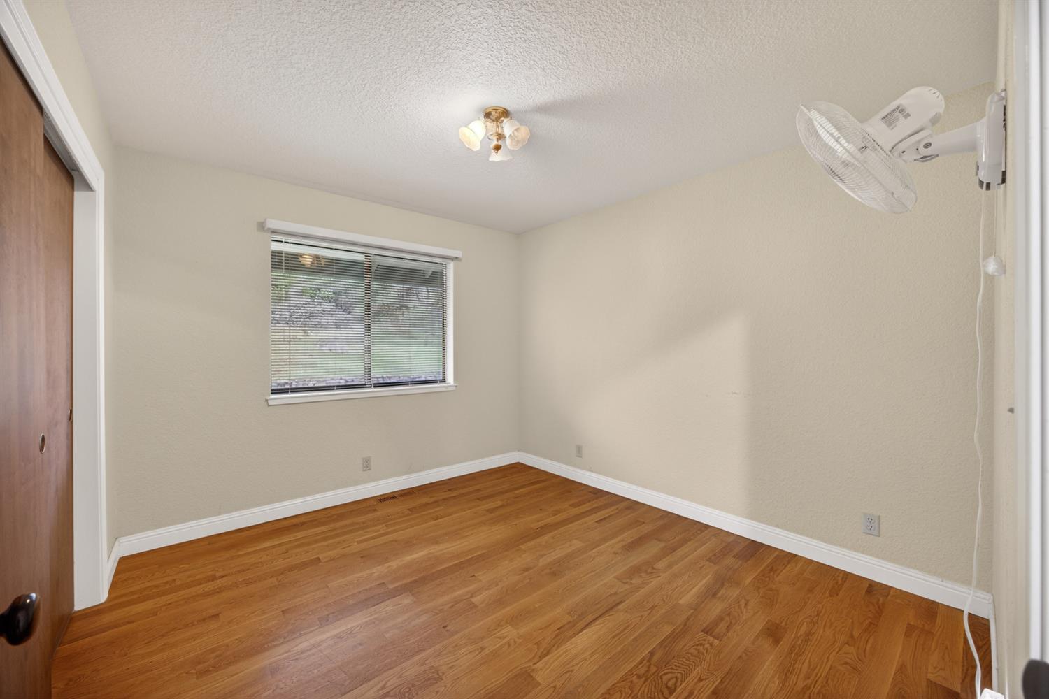 3281 Yearling Trail Placerville, CA 95667 - Photo 36 of 61 an empty room with wooden floor and windows