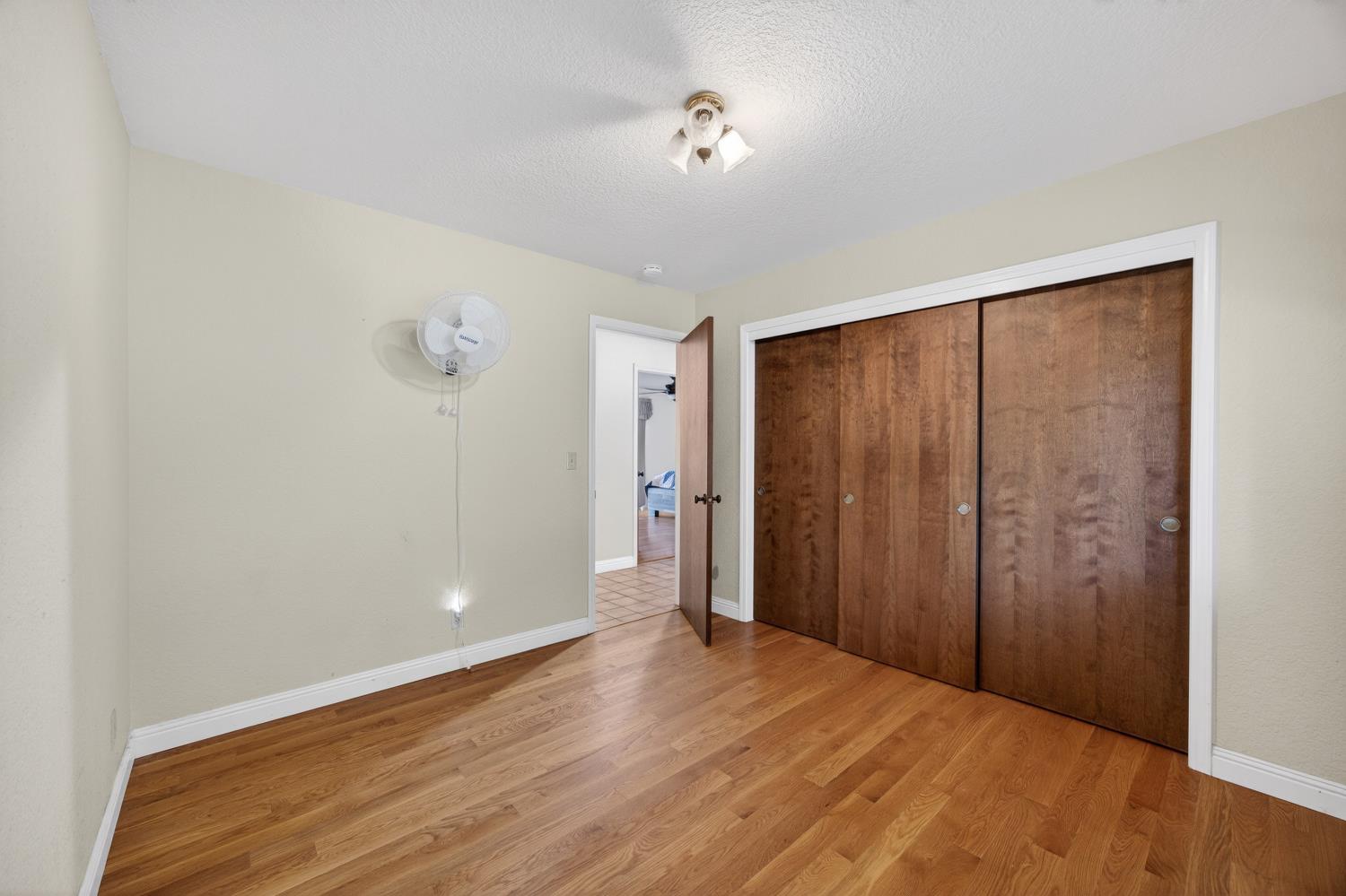 3281 Yearling Trail Placerville, CA 95667 - Photo 37 of 61 a view of an empty room with wooden floor and a window