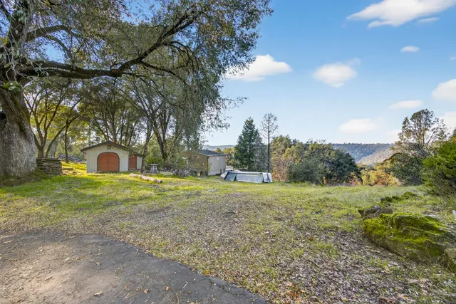 a view of a wooden house with a yard