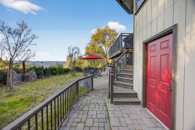 a patio with water fountain and barbeque oven