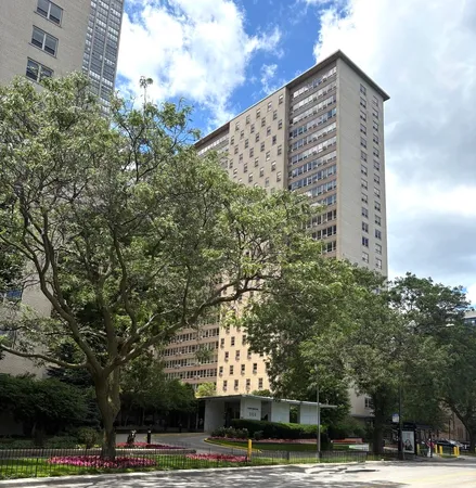 a view of a tall building next to a road