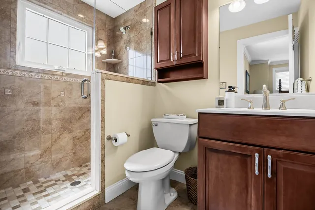a bathroom with a toilet sink and mirror