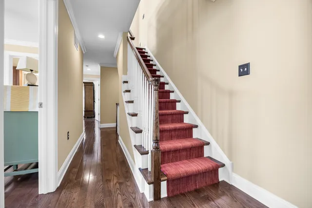 a view of entryway and hall with wooden floor