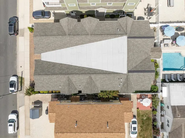 an aerial view of residential houses with outdoor space