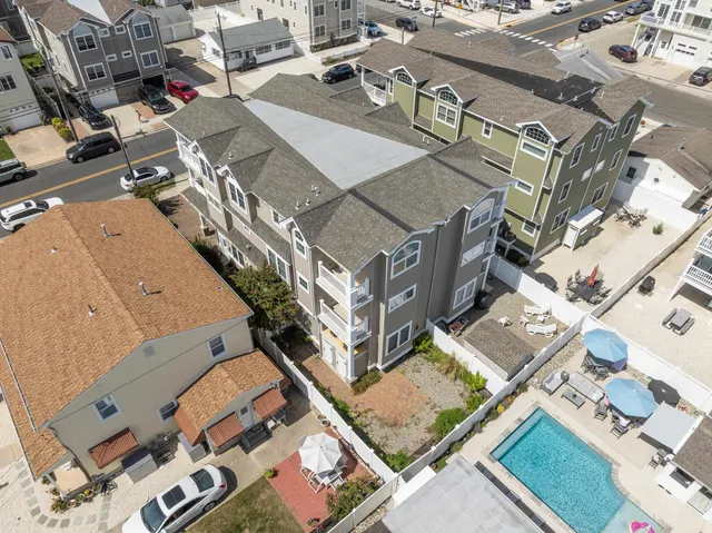 an aerial view of a residential building with parking