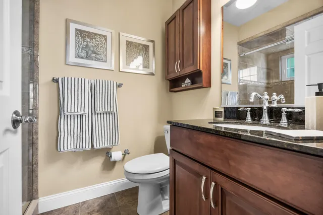 a bathroom with a sink a toilet and mirror