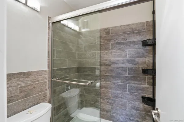 a bathroom with a toilet and a shower