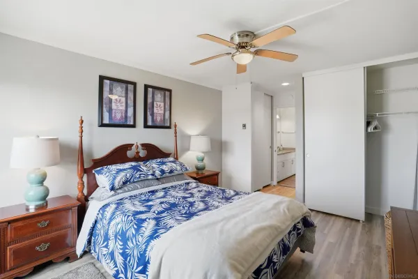 a bedroom with a large bed and a chandelier