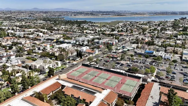 an aerial view of a residential apartment building with a yard