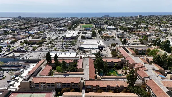 an aerial view of multiple houses with yard