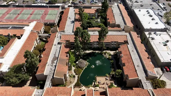 an aerial view of a residential houses with street