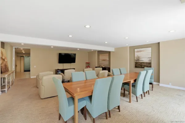 a living room with furniture and large windows