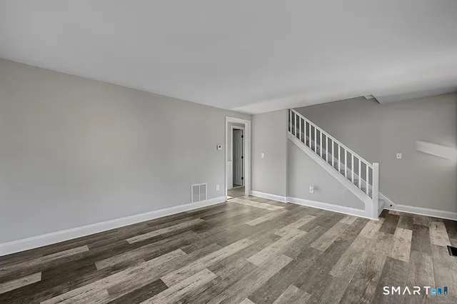 a view of an entryway with wooden floor