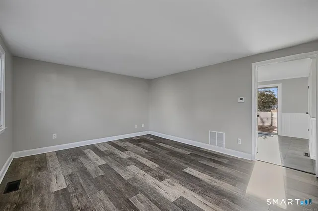 a view of room with wooden floor