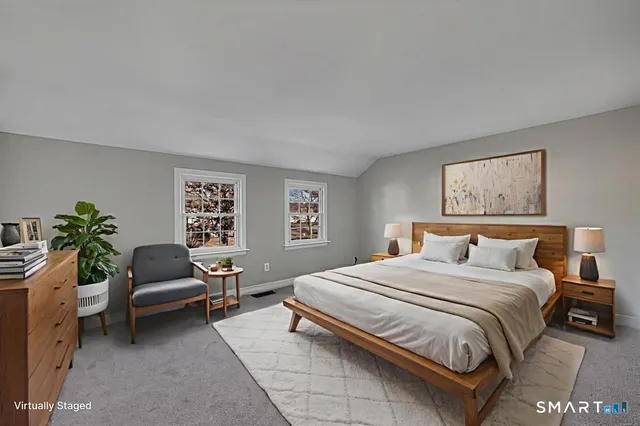 a bedroom with a bed and a couch