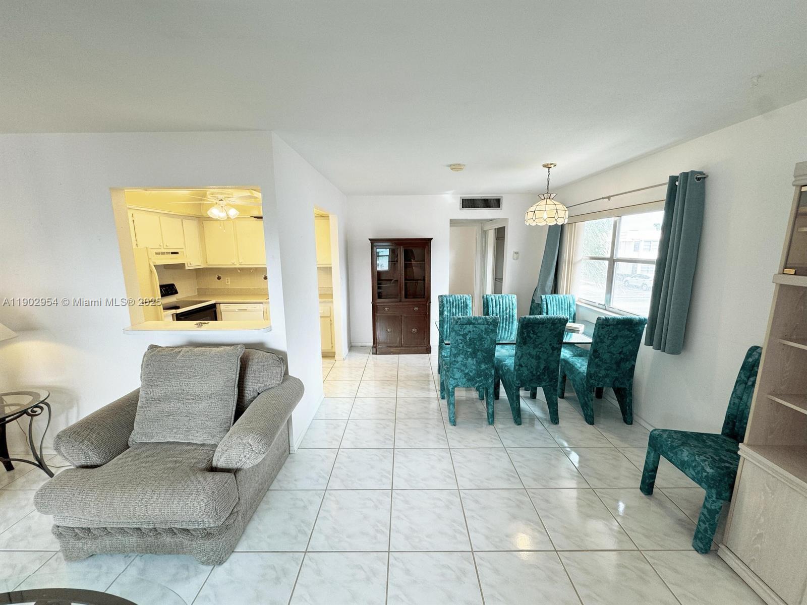 379 Saxony Lane, Unit 379 Delray Beach, FL 33446 - Photo 5 of 16 a living room with furniture and a large window