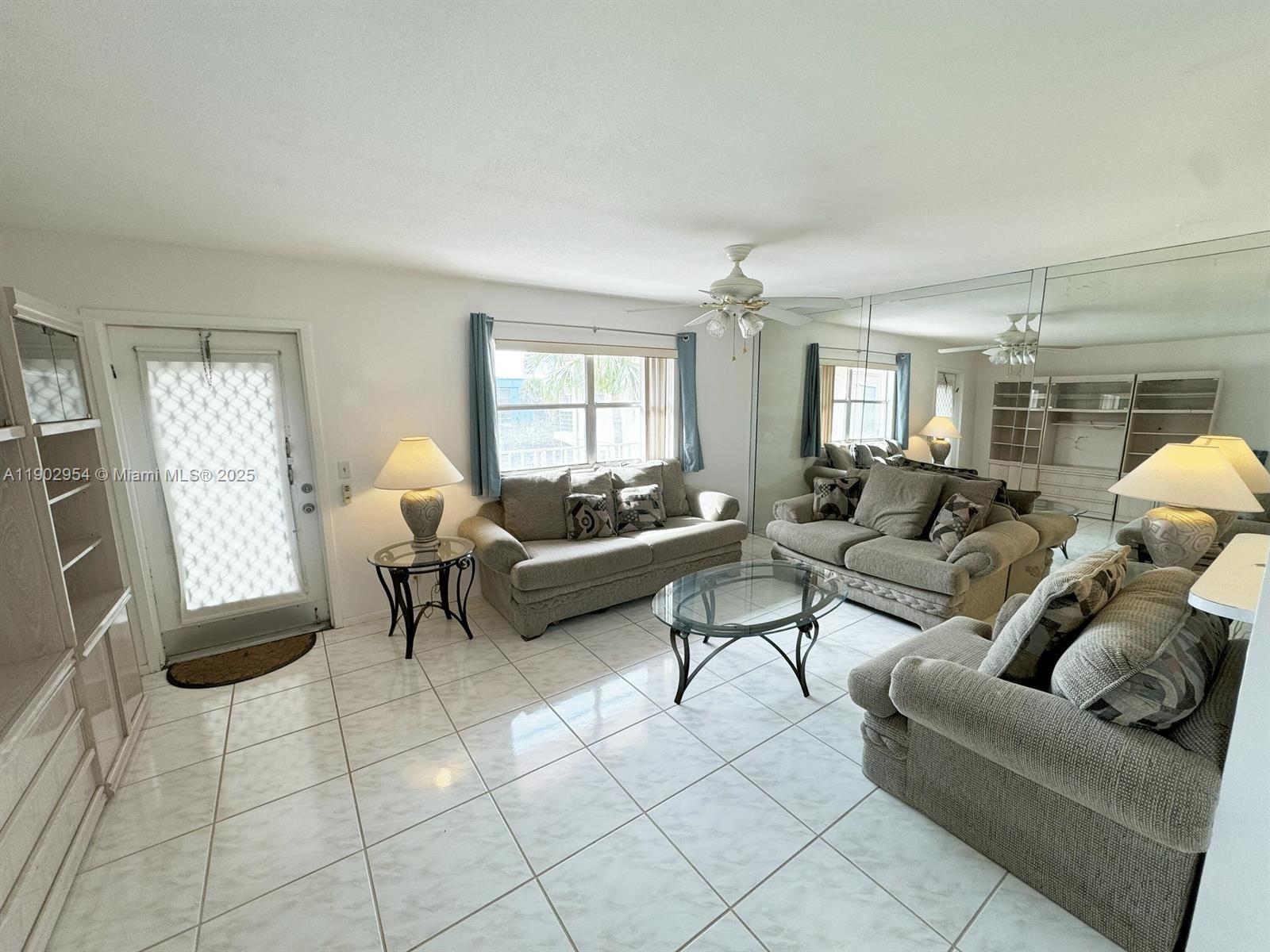 379 Saxony Lane, Unit 379 Delray Beach, FL 33446 - Photo 6 of 16 a living room with furniture and a couch