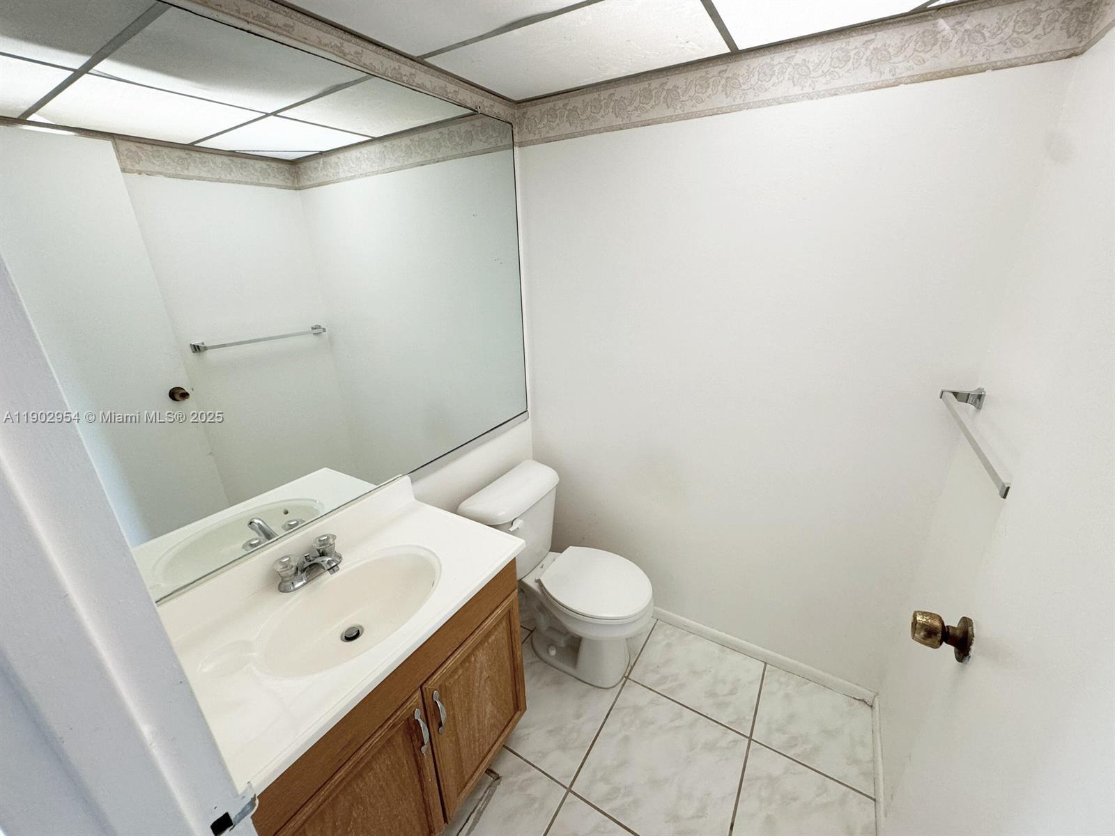 379 Saxony Lane, Unit 379 Delray Beach, FL 33446 - Photo 7 of 16 a bathroom with a sink and mirror