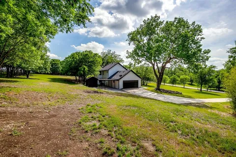 a view of a house with swimming pool and a yard