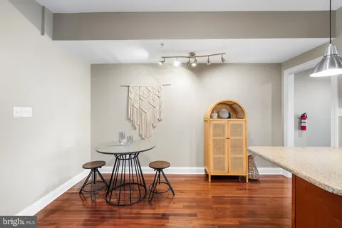 a view of a room with wooden floor and furniture